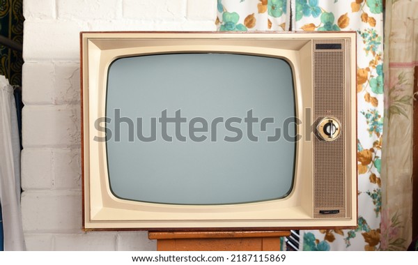 Old TV set in a rustic\
interior.