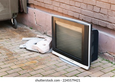 Old TV is thrown into a street dump. Selective soft focus - Shutterstock ID 2245579421