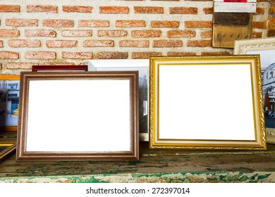 old two photo frames on the wooden table