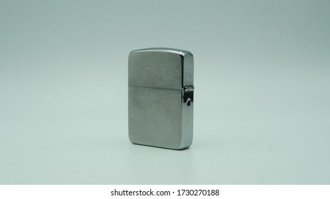 Old Type Metal Lighter. In White Background.