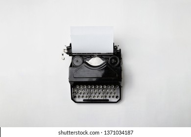 Old Typewriter and a blank sheet of paper inserted. Isolated on White Background. High Resolution. Top view.