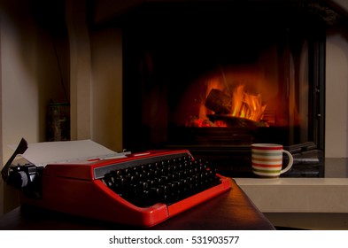 Old typewriter and a cup of coffee in front of fireplace