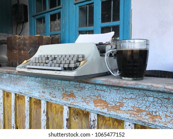 old typewriter with a mug of beer