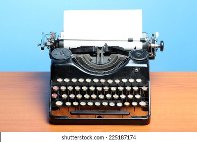 Old Typewriter On Wood On A Blue Background