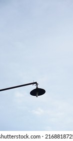 Old And Ugly Street Lamp With Blue Sky Background And Negative Space Tu Put Text