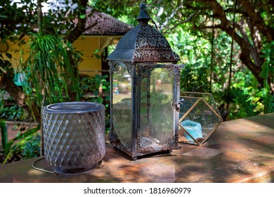Old uncared for vintage objects on display in the sunlight in a rustic country bushland garden