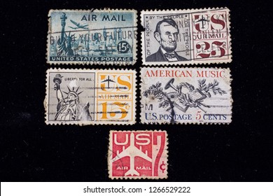 Old UNITED STATES OF AMERICA airmail stamps: Statue of Liberty, 1941-1946, President Abraham Lincoln, circa 1959 
 7 cent Air Mail-1960 ,A 5 cent US stamp showing musical instruments-1965.