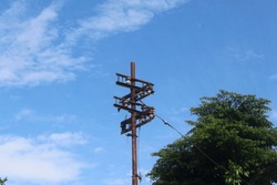 An Old, Unused Power Line Pole With A Blue Sky In The Background On A Clear Morning.