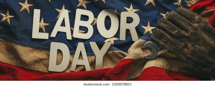 Old US American flag with a worn work glove holding a crescent wrench with Labor day text. Labor day and American blue collar worker concept. - Shutterstock ID 2350078851