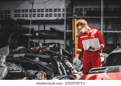 Old used car part warehouse worker checking inventory in garage. Staff worker working in recycle motor junkyard auto parts management. - Powered by Shutterstock