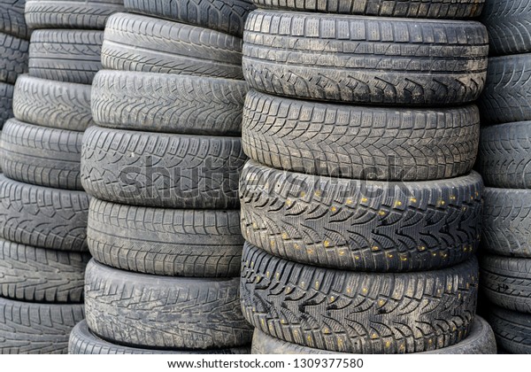 old used car\
tyres, stacked at car\
service
