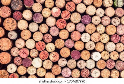 Old Used corks plugs from various types of wine on dark background