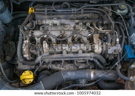 Old used diesel engine with rusty and dirty auto parts, water infiltration and bad car maintenance.  
