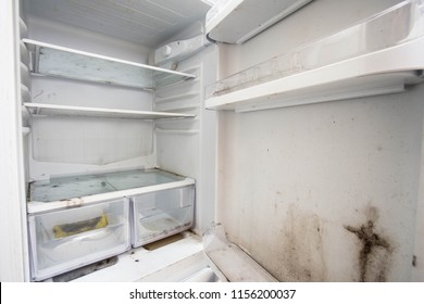 Old used dirty refrigerator with mold,aged junk in the kitchen