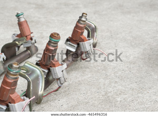 Old and used fuel injectors and fuel\
injector rail for gasoline engine, selective\
focus