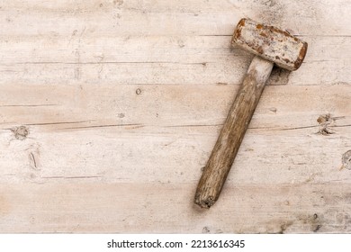 Old Used Hammer Lying On A Wooden Workbench