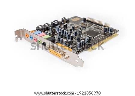 Old used internal sound card for PCI bus used in desktop computers on a white background, close-up in selective focus
