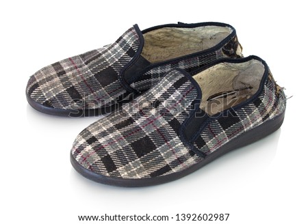 Old used mufflers with holes. Isolated on white background with shadow reflection. With clipping path. Worn old slippers on white bg. With vector path. Old-timer softie shoes with checked pattern