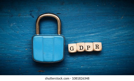 Old Used Padlock On A Blue Rustic Wooden Background, GDPR Concept Image