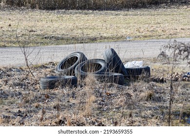 Old Used Tires On Withered Grass, Rubbish.