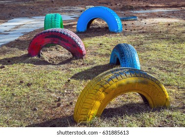 Old, used wheels of different colors on the playground in the park. - Powered by Shutterstock
