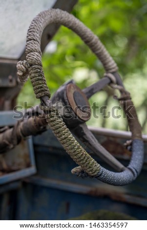 Old useless steering wheel in the forest