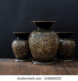 old vases in a wood table in black background