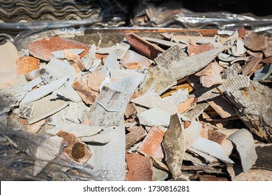 Old and very dangerous asbestos roof waste. Asbestos dust in the environment.