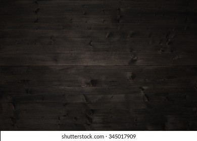 Old very dark black wood table top timber background texture. Table or natural floor panel grain 