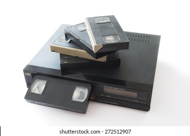 Old VHS Video Cassettes On Old Video Recorder Isolated On White Background.