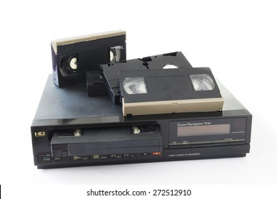 Old VHS Video Cassettes On Old Video Recorder Isolated On White Background.