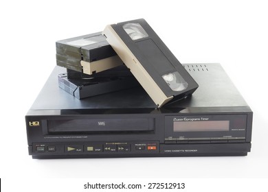 Old VHS Video Cassettes On Old Video Recorder Isolated On White Background.