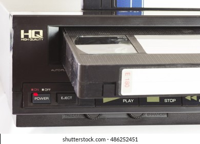 Old VHS Video Cassettes And Old Video Recorder. Closeup. 