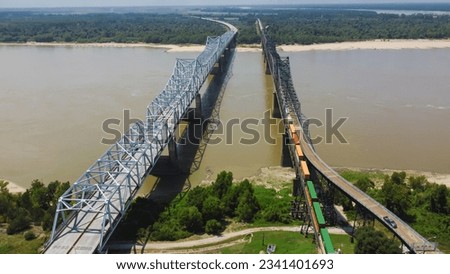 Old Vicksburg Bridge or Mississippi River Bridge with freight train crossing all-steel railroad truss river, a cantilever bridge carrying one rail line across the Mississippi River, USA. Aerial view