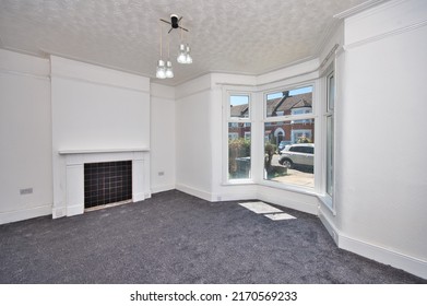 Old Victorian House Living Room Refurbished with Grey Carpet and Flash White Painted Walls - Unfurnished Empty Room in London UK 