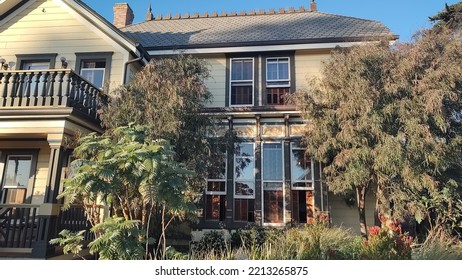 Old Victorian Style House With Trees Out Front 