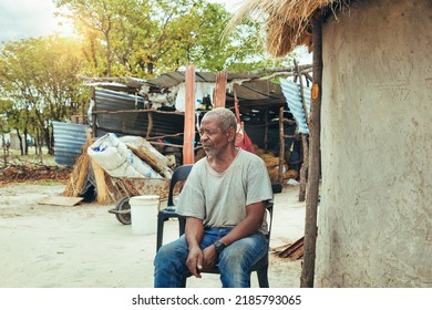 Old Village Farmer Man Sitting In The Yard At Sunset