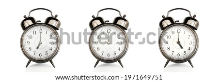 Old vintage alarm clocks at different time of the days isolated on panoramic white background. Morning, noon,afternoon,evening concept