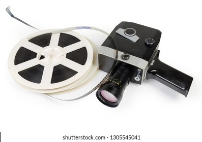 Old Vintage Amateur Film Movie Camera Powered By Clockwork Motor And Reels Of Color Motion Picture Films Super 8mm Format On A White Background 
