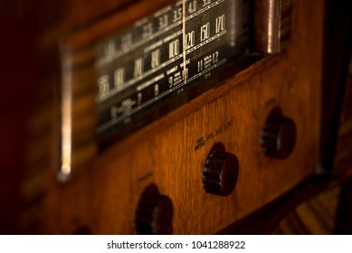 Old, vintage antique stand-up radio 1930s, with dials and push buttons, warm wood tone, music, plays music, musical, listen, history, old-fashioned, 