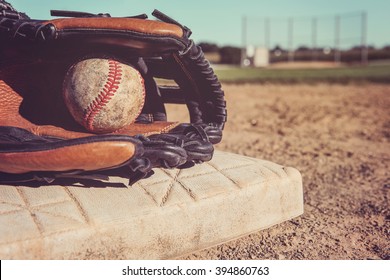 Old Vintage Baseball and glove resting on a base