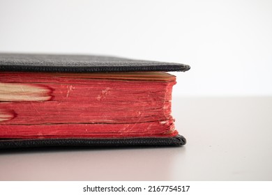 Old Vintage Black Closed Hardcover Book With A Satin Bookmark. Close Up Shot, Shallow Depth Of Field, White Background, No People