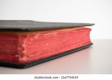 Old Vintage Black Closed Hardcover Book With A Satin Bookmark. Close Up Shot, Shallow Depth Of Field, White Background, No People