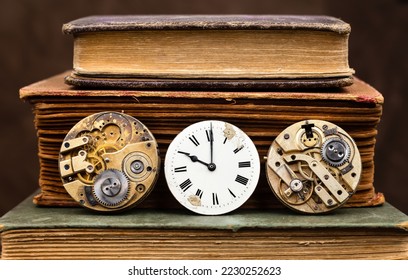 Old vintage books with antique clock and clockworks. Knowledge, storytelling, story time, history background.