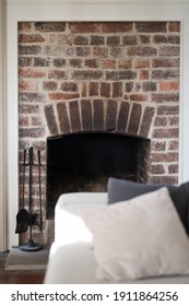 Old vintage brick fireplace with metal stoker