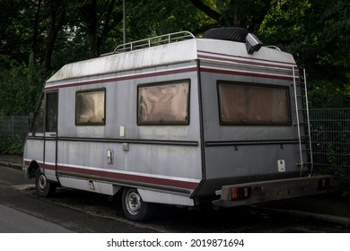 Old Vintage Camper Van Parked On The Street From Behind