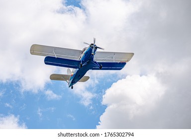 Old and vintage Cessna 172 plane flying above the clouds against the blue sky