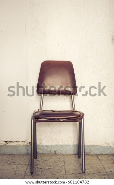 old-vintage-chair-against-wall-600w-6011