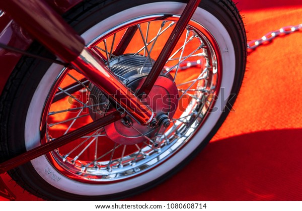 old\
vintage classic Motorcycle wheel on the red carpet, concept\
presentation of the event on the motorcycle\
theme