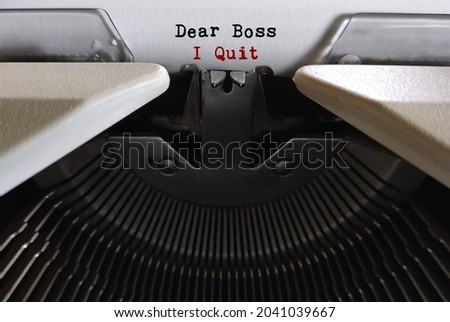 Old vintage classic typewriter with text DEAR BOSS I QUIT, concept of decision making to quit job ,to resign from paid work , stop being a full time employee and leave workplace